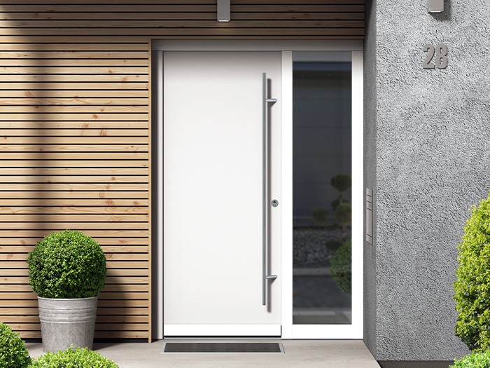 Sleek, modern style front door with a large stainless steel handle.